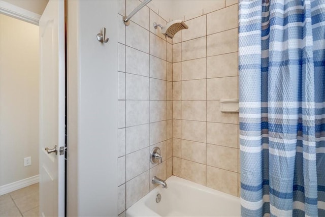 full bath with baseboards, tile patterned floors, and shower / tub combo