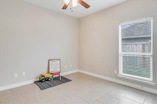 unfurnished room with light tile patterned floors, baseboards, and a ceiling fan