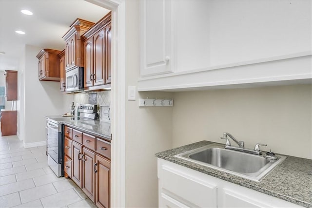 bar with appliances with stainless steel finishes, a sink, recessed lighting, decorative backsplash, and light tile patterned floors