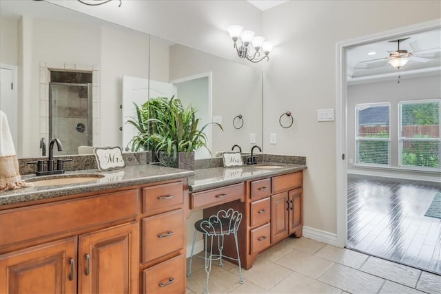 full bathroom featuring double vanity, a sink, tile patterned floors, and a shower stall