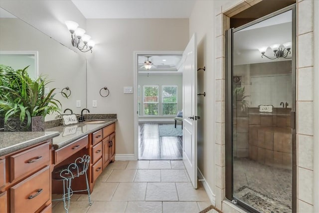 full bath featuring ceiling fan, a shower stall, tile patterned floors, and vanity