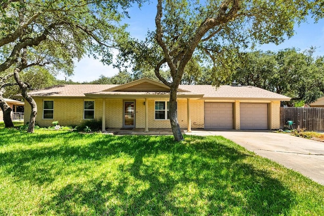 116 Greenway Ln, Rockport, TX 78382 - ranch-style house featuring an attached garage, driveway, brick siding, and a porch