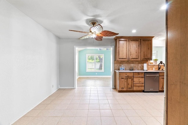 116 Greenway Ln, Rockport, TX 78382 - kitchen with dishwasher, ceiling fan, light countertops, tasteful backsplash, and brown cabinetry