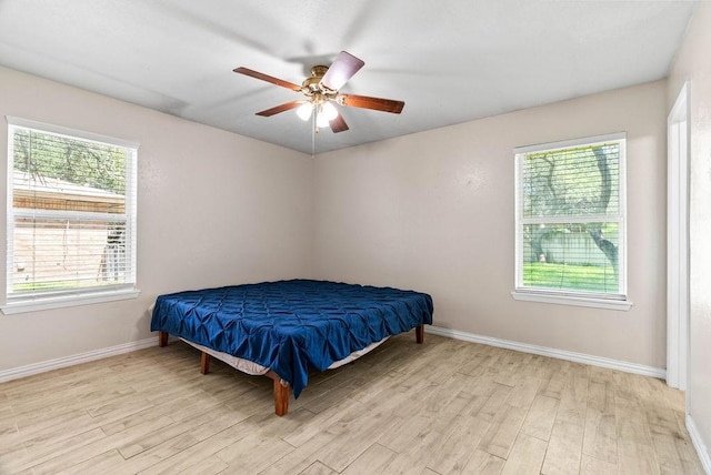 116 Greenway Ln, Rockport, TX 78382 - bedroom featuring wood finished floors, multiple windows, and ceiling fan