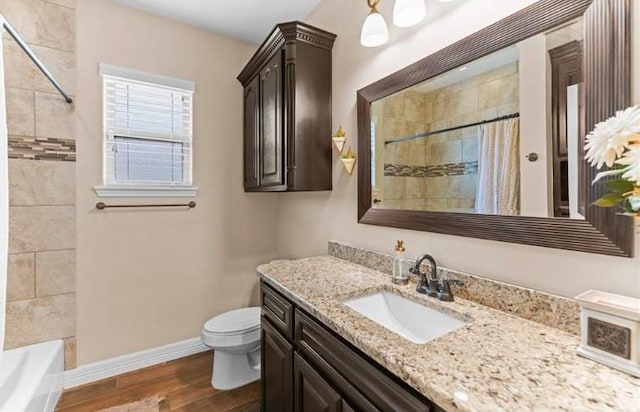2013 Magnolia Falls Dr, Corpus Christi, TX 78415 - bathroom with toilet, vanity, baseboards, and wood finished floors
