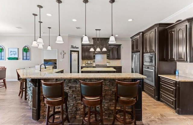2013 Magnolia Falls Dr, Corpus Christi, TX 78415 - kitchen with ornamental molding, stainless steel appliances, tasteful backsplash, and a spacious island