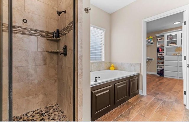 2013 Magnolia Falls Dr, Corpus Christi, TX 78415 - full bathroom with a shower stall, baseboards, a walk in closet, and a garden tub