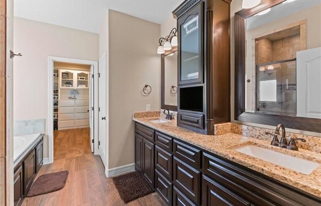 2013 Magnolia Falls Dr, Corpus Christi, TX 78415 - full bathroom featuring double vanity, a sink, a stall shower, and wood finished floors