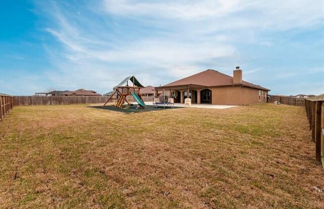 2013 Magnolia Falls Dr, Corpus Christi, TX 78415 - view of yard featuring a fenced backyard and a playground