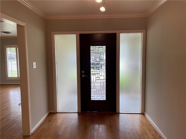 foyer entrance featuring a wealth of natural light, wood-type flooring, and crown molding