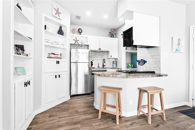 14721 Whitecap Blvd Unit 115, Corpus Christi, TX 78418 - kitchen featuring freestanding refrigerator, open shelves, a peninsula, white cabinets, and wood finished floors