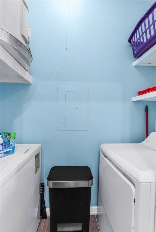 14721 Whitecap Blvd Unit 115, Corpus Christi, TX 78418 - laundry area with electric panel, washing machine and dryer, and dark wood-style flooring
