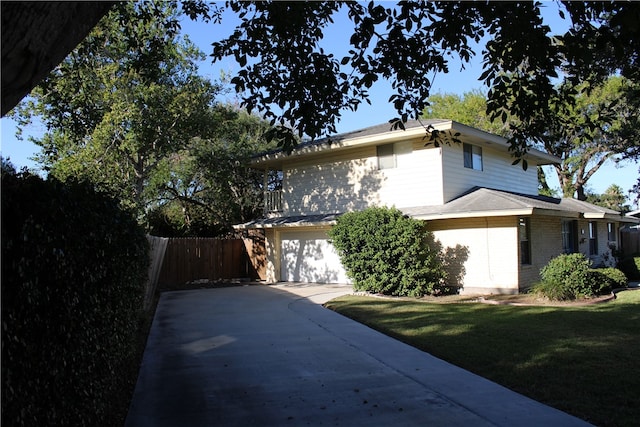 view of home's exterior with a garage and a yard