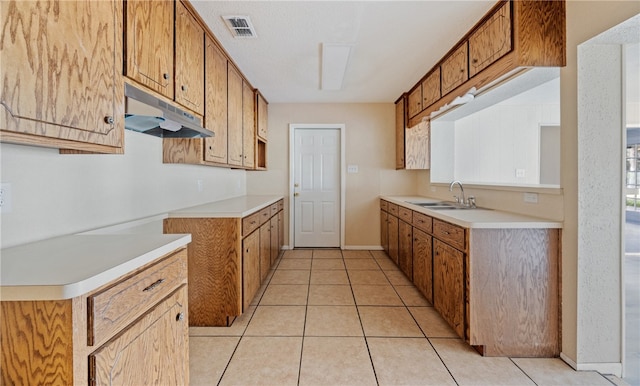 kitchen featuring light tile patterned flooring and sink