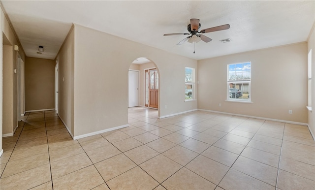 tiled empty room with ceiling fan