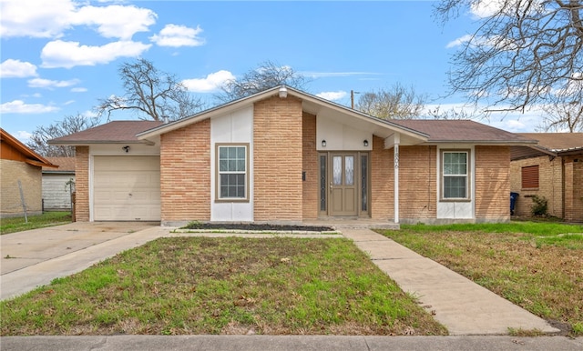 ranch-style home with a garage and a front lawn