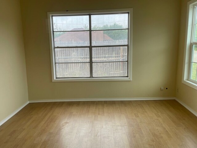 unfurnished room with light wood-type flooring