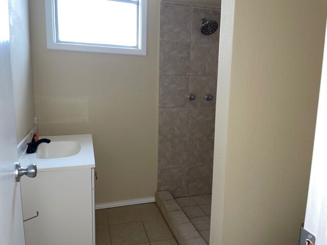 bathroom with vanity, tile patterned flooring, and tiled shower