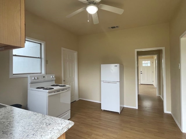 kitchen with white appliances, ceiling fan, and light wood-type flooring