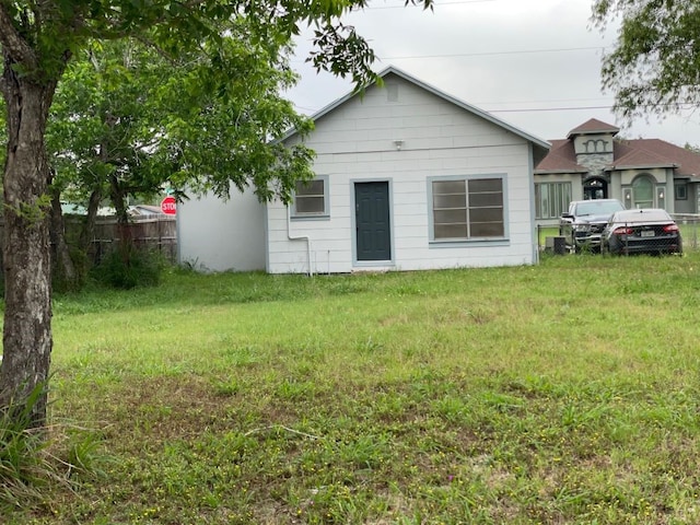 rear view of house featuring a lawn