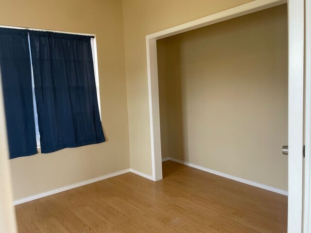 spare room with light hardwood / wood-style flooring