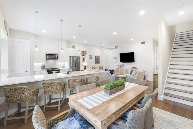 dining space featuring recessed lighting, visible vents, ceiling fan, wood finished floors, and stairs