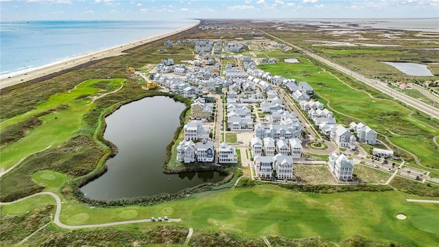 birds eye view of property featuring a water view, a beach view, and golf course view