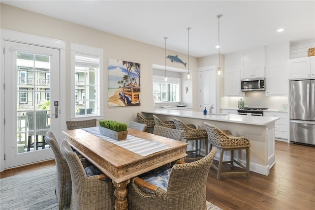 dining space with dark wood-style floors and recessed lighting