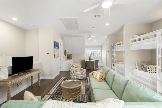 living room with recessed lighting, dark wood-type flooring, visible vents, baseboards, and attic access