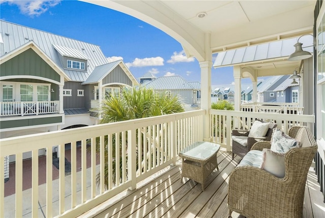 wooden deck with an outdoor hangout area and a residential view