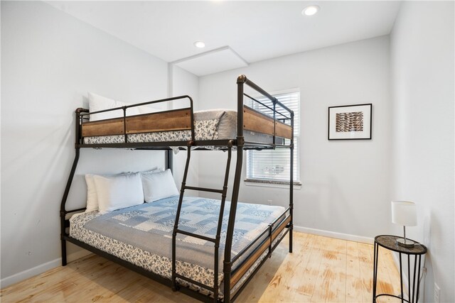 bedroom with hardwood / wood-style flooring