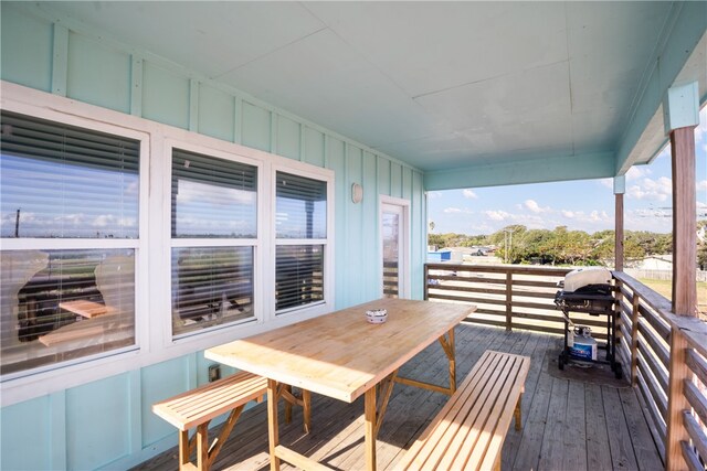 wooden balcony featuring a grill and a wooden deck