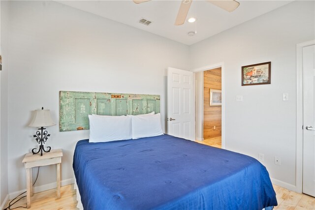 bedroom with light hardwood / wood-style flooring and ceiling fan