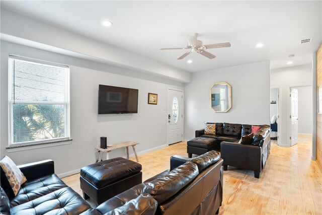 living room with light wood-type flooring and ceiling fan