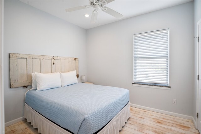 bedroom with light hardwood / wood-style floors and ceiling fan