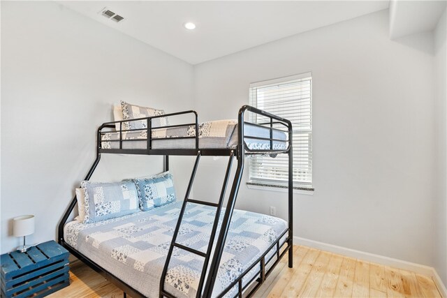 bedroom with hardwood / wood-style flooring