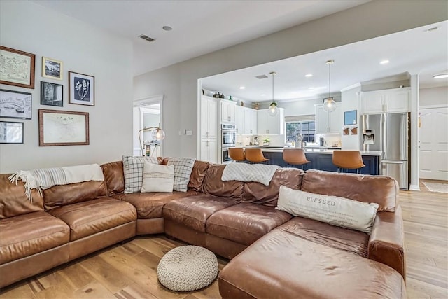 6046 Tarafaya Dr, Corpus Christi, TX 78414 - living room featuring light wood finished floors and recessed lighting