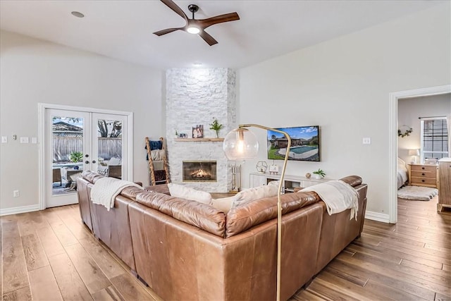 6046 Tarafaya Dr, Corpus Christi, TX 78414 - living area featuring a ceiling fan, light wood-style flooring, a stone fireplace, and french doors