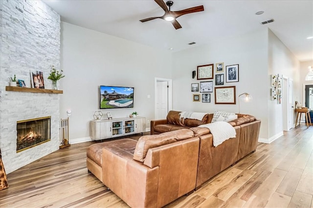 6046 Tarafaya Dr, Corpus Christi, TX 78414 - living area with ceiling fan, a fireplace, light wood-style floors, and a towering ceiling