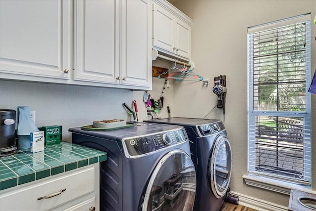 6046 Tarafaya Dr, Corpus Christi, TX 78414 - laundry area featuring cabinet space, independent washer and dryer, healthy amount of natural light, and wood finished floors