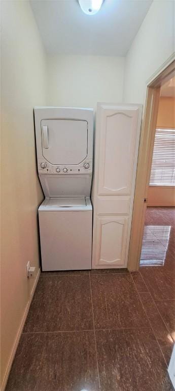 laundry room featuring stacked washer and clothes dryer