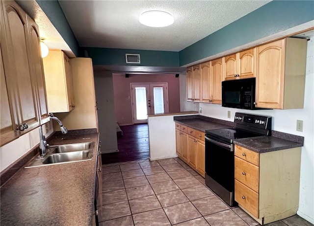 5406 Sugar Creek Dr, Corpus Christi, TX 78413 - kitchen featuring black appliances, a textured ceiling, light brown cabinetry, dark countertops, and light tile patterned floors