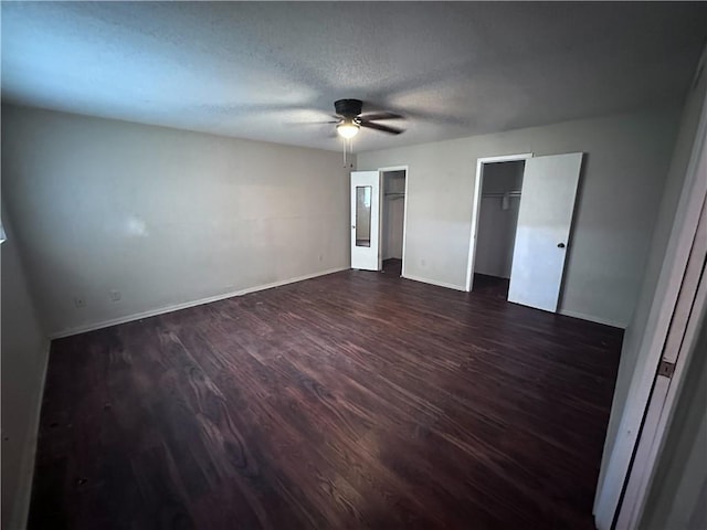 5406 Sugar Creek Dr, Corpus Christi, TX 78413 - unfurnished bedroom with dark wood-style flooring, multiple closets, ceiling fan, and a textured ceiling