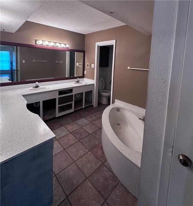 5406 Sugar Creek Dr, Corpus Christi, TX 78413 - bathroom featuring double vanity, a garden tub, and a textured ceiling