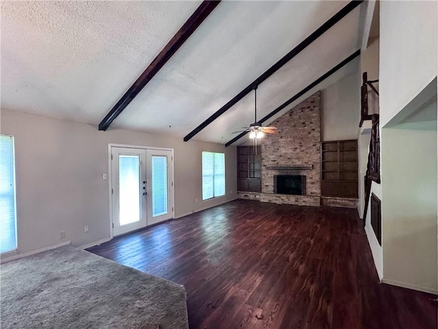 5406 Sugar Creek Dr, Corpus Christi, TX 78413 - unfurnished living room featuring a fireplace, wood finished floors, a textured ceiling, ceiling fan, and french doors
