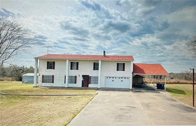 view of front of house featuring a garage and a front lawn