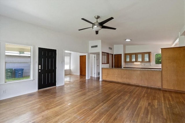1009 Driftwood Pl, Corpus Christi, TX 78411 - unfurnished living room with wood-type flooring, ceiling fan, and healthy amount of natural light