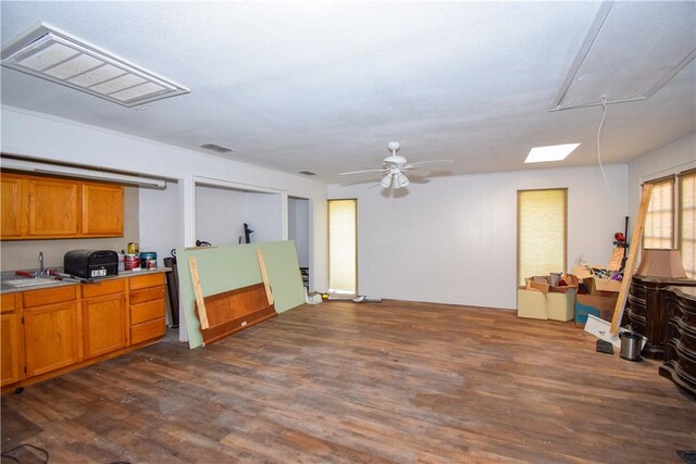 4410 Hebert, Corpus Christi, TX 78413 - kitchen with dark wood finished floors, a ceiling fan, visible vents, light countertops, and brown cabinets