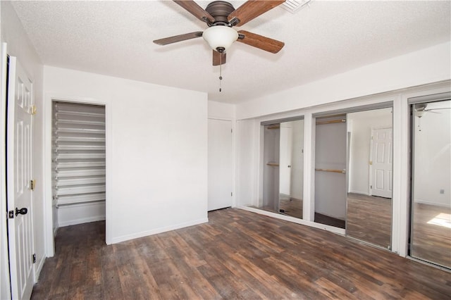 4410 Hebert, Corpus Christi, TX 78413 - unfurnished bedroom featuring multiple closets, baseboards, wood finished floors, and a textured ceiling