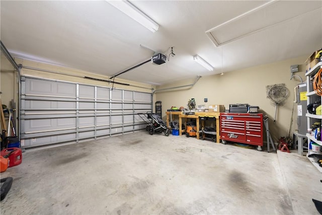 garage with water heater and a garage door opener
